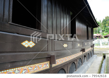 SUMATERA, INDONESIA -JUNE 10, 2014: Traditional and colorful wood carving detail at Surau Nagari Lubuk Bauk at Tanah Datar, Sumatera Barat, Indonesia. It was place for Muslim do religious activity. 79542618