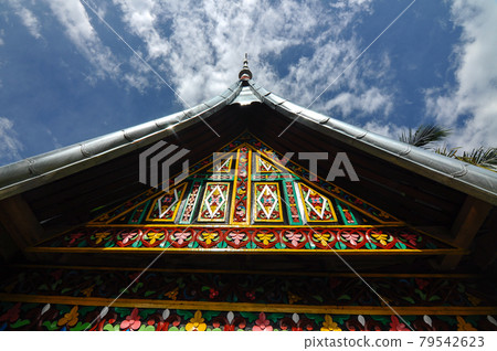 SUMATERA, INDONESIA -JUNE 10, 2014: Traditional and colorful wood carving detail at Surau Nagari Lubuk Bauk at Tanah Datar, Sumatera Barat, Indonesia. It was place for Muslim do religious activity. 79542623