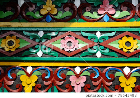 SUMATERA, INDONESIA -JUNE 10, 2014: Traditional and colorful wood carving detail at Surau Nagari Lubuk Bauk at Tanah Datar, Sumatera Barat, Indonesia. It was place for Muslim do religious activity. SUMATERA, INDONESIA -JUNE 10, 2014: Traditional and colorful wood carving detail at Surau Nagari Lubuk Bauk at Tanah Datar, Sumatera Barat, Indonesia. It was place for Muslim do religious activity. 79543498