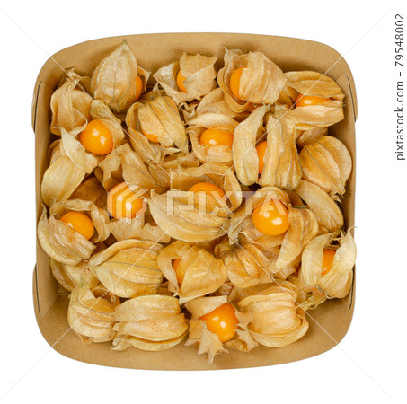 Fresh goldenberries in their husk, in a paper snacktray. Also ground cherry, Cape gooseberry, uchuva or poha, fruits of Physalis peruviana, used as garnish and dessert. Close-up from above food photo. 79548002