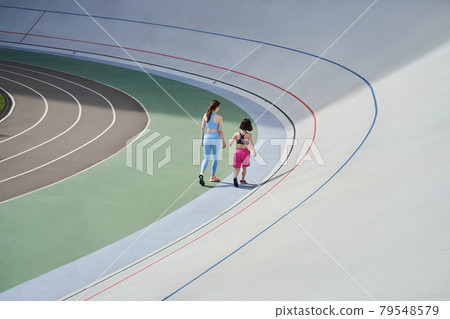 Diverse girls wearing sportswear running in the stadium Diverse girls wearing sportswear running in the stadium 79548579