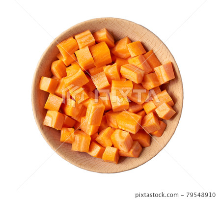 dice carrots in a wooden bowl isolated on white background, top view. dice carrots in a wooden bowl isolated on white background, top view. 79548910