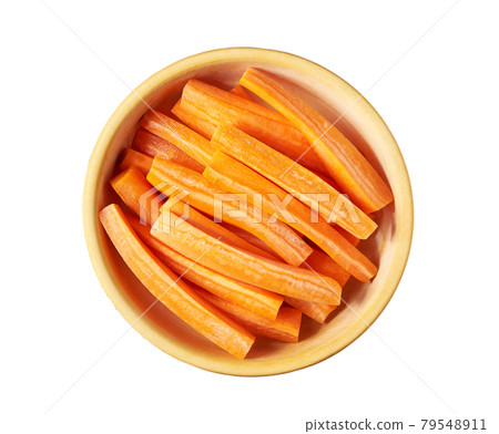 Carrot sticks in a wooden bowl isolated on white background, top view. n 79548911
