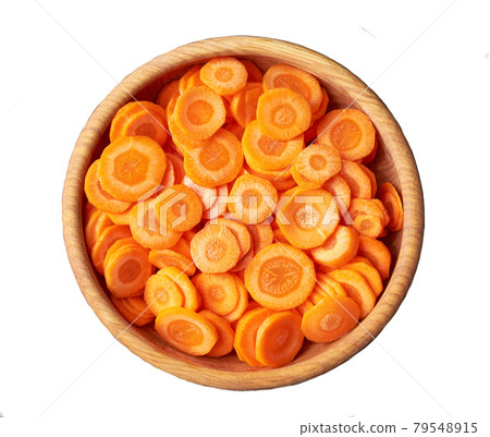 chopped carrots in a wooden bowl isolated on white background, top view. chopped carrots in a wooden bowl isolated on white background, top view. 79548915