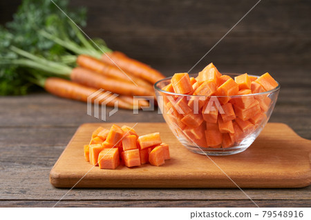 diced carrots on a wooden table, selective focus, rustic style. diced carrots on a wooden table, selective focus, rustic style. 79548916