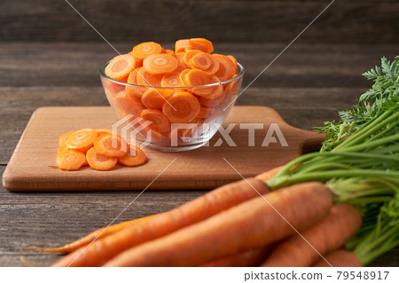 chopped carrots on a cutting board, selective focus. chopped carrots on a cutting board, selective focus. 79548917