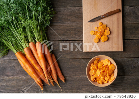 chopped carrots on a cutting board, top view. 79548920