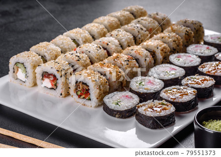 Delicious fresh rolls in various sets. Japanese food with avocado, shrimp, crab and salmon 79551373