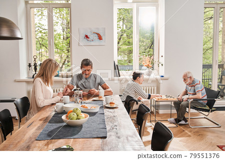 Man drinking tea with his caregiver at the nurse house Man drinking tea with his caregiver at the nurse house 79551376