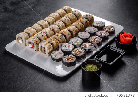 Delicious fresh rolls in various sets. Japanese food with avocado, shrimp, crab and salmon Delicious fresh rolls in various sets. Japanese food with avocado, shrimp, crab and salmon 79551378