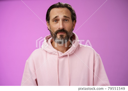 Upset worried unconfident adult bearded caucasian man grey hair frowning look hopefully nervously waiting important news, standing anxious hesitant unhappy, standing purple background unwell 79551549