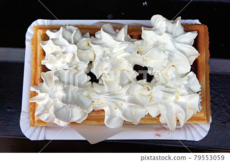 Waffle with whipped cream and chocolate as food street dessert. Waffle with whipped cream and chocolate as food street dessert. 79553059