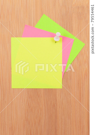 Colored Sticky Notes Pinned to the Wooden Message Board 79554461