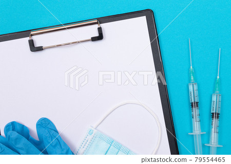 Vaccination or Revaccination Concept - Two Medical Syringe on Blue Table Vaccination or Revaccination Concept - Two Medical Syringe on Blue Table 79554465