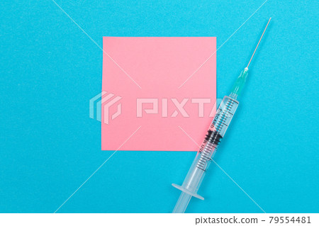 Vaccination or Revaccination Concept - A Medical Syringe on Blue Table 79554481