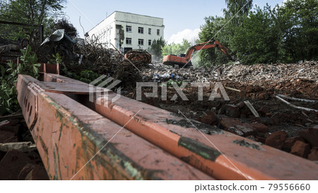 Excavators demolish the building. Dismantling of construction Excavators demolish the building. Dismantling of construction 79556660