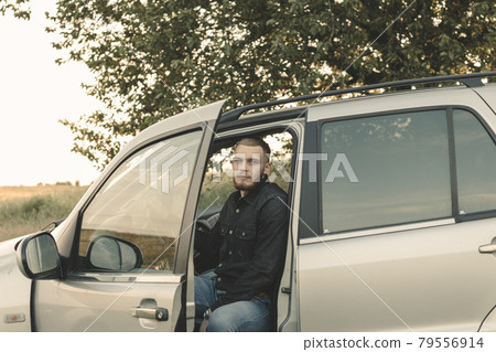 Man cowboy western car red light sunset summer 79556914