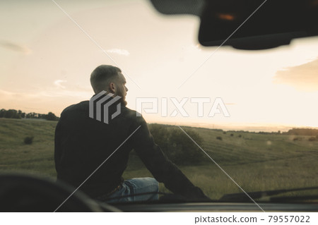 Man cowboy western car red light sunset summer 79557022