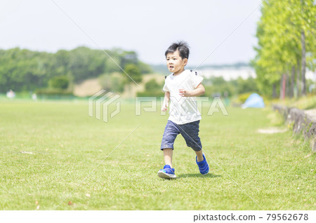4-year-old boy running around the lawn 4-year-old boy running around the lawn 79562678