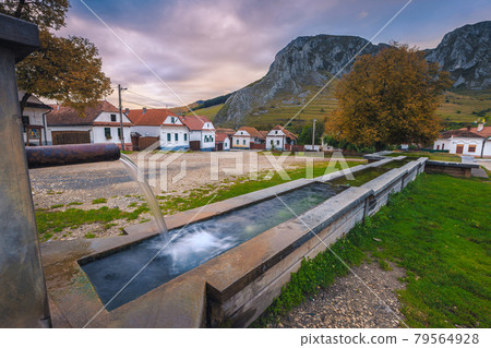 Fountain in Rimetea center at sunrise, Transylvania, Romania 79564928