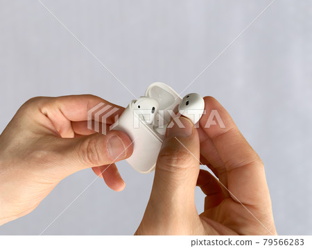 Wireless earphones in my hand 79566283