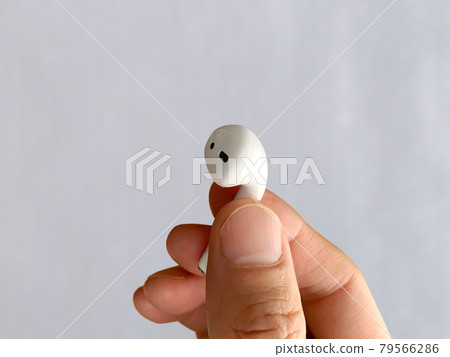 Wireless earphones in my hand 79566286
