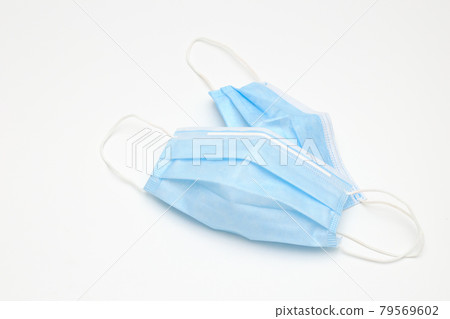Top view and close-up to light blue colour medical protective mask are on white background with shadow and copy space. Mask for protect virus Top view and close-up to light blue colour medical protective mask are on white background with shadow and copy space. Mask for protect virus 79569602