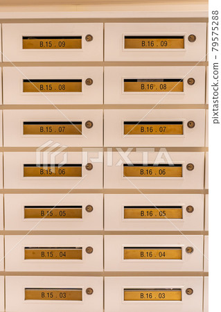 Vertical photo of mailbox array at postal room in apartment building Vertical photo of mailbox array at postal room in apartment building 79575288
