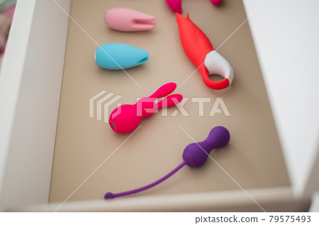 A collection of vibrators and dildos in a white chest of drawers. Private collection of sex toys. A collection of vibrators and dildos in a white chest of drawers. Private collection of sex toys. 79575493