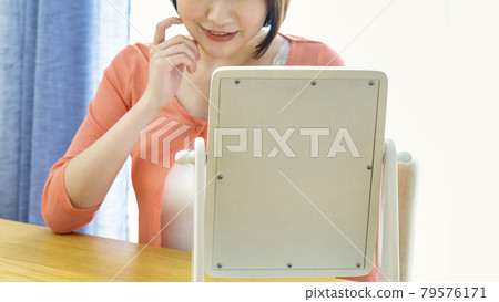 Image cut of a young woman checking makeup 79576171