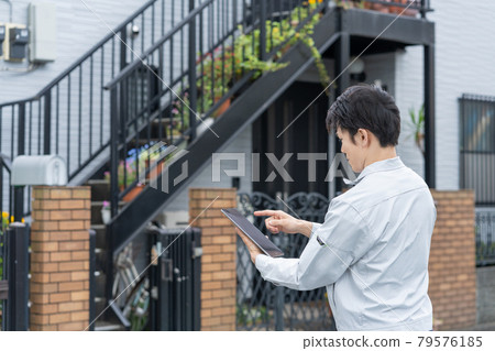 Young male worker doing house inspection work Young male worker doing house inspection work 79576185