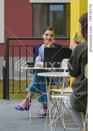 Charming happy woman student using laptop computer to prepare for the course work. Charming happy woman student using laptop computer to prepare for the course work. 79576379