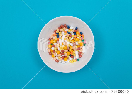 Pharmaceutical Industry and Medicinal Products - Different Colored Pills on Plate Pharmaceutical Industry and Medicinal Products - Different Colored Pills on Plate 79580090