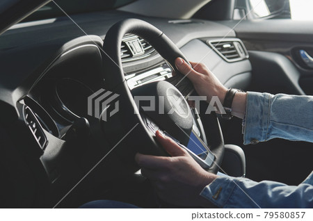 Young man steering car 79580857