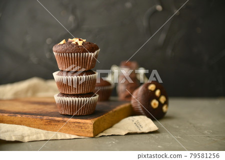 Chocolate muffins with nuts on a wooden table. delicious sweet dessert. rustic style. 79581256