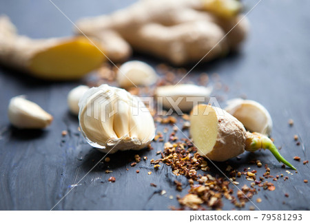 Garlic, species and ginger on a black background. Food ingredients. Cooking concept.Food photo. Fresh natural garlic on black table 79581293