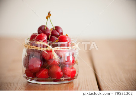 Red morello cherries - summer berries on a wooden table. Fresh red heart cherries. vitamins. Healthy nutrition 79581302