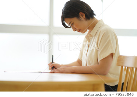 A woman practicing ballpoint pen writing 79583046
