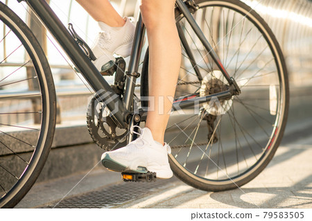 Close up picture of a female cyclist on a bike Close up picture of a female cyclist on a bike 79583505