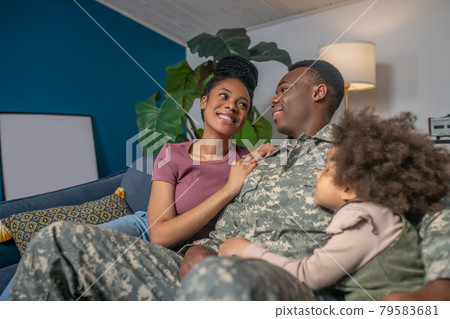 Man and woman looking at each other and daughter Man and woman looking at each other and daughter 79583681