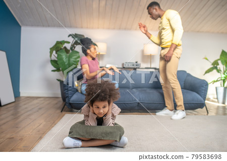 Parents swearing nervously and unhappy little daughter Parents swearing nervously and unhappy little daughter 79583698