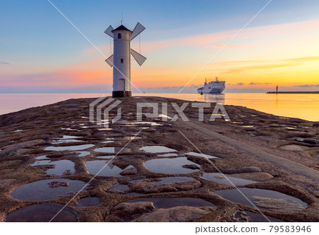 Swinoujscie. The famous mill lighthouse at sunrise. Swinoujscie. The famous mill lighthouse at sunrise. 79583946