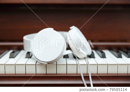 upright piano with headphones