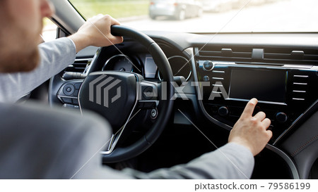 Man driving own new car sits on seat hand, holds steering wheel in modern auto 79586199