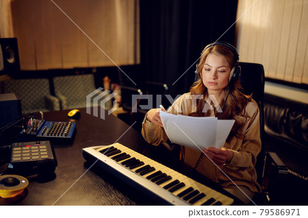 Female engineer in headphones, recording studio Female engineer in headphones, recording studio 79586971