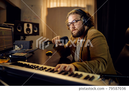 Sound engineer holds microphone, recording studio 79587036