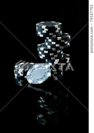 Stack of Casino gambling chips isolated on black reflective background Stack of Casino gambling chips isolated on black reflective background 79587765