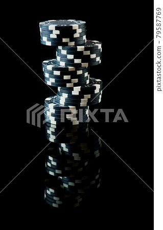 Stack of Casino gambling chips isolated on black reflective background Stack of Casino gambling chips isolated on black reflective background 79587769