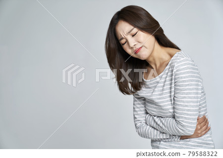 abdominal pain, menstruation, menstrual cramps, pain, young woman, nukki, gray background 79588322