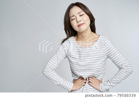 abdominal pain, menstruation, menstrual cramps, pain, young woman, nukki, gray background abdominal pain, menstruation, menstrual cramps, pain, young woman, nukki, gray background 79588339